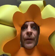 Tom wearing a carboard lion maine mask